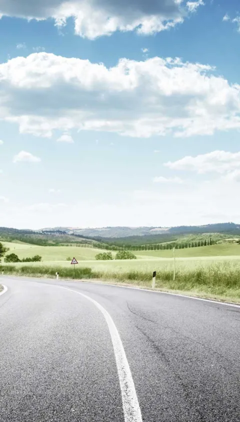 road in a green field